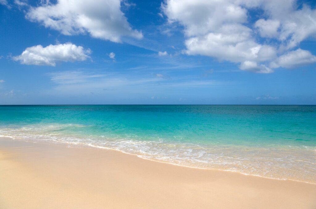 The sand, sky, and water, at a Grenada beach.