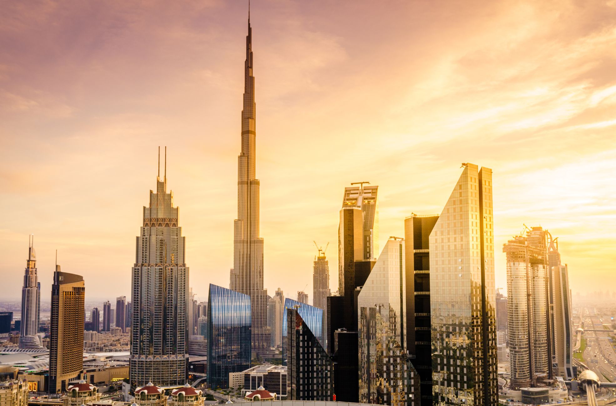 A picture of Dubai with the evening sun shining on buildings.