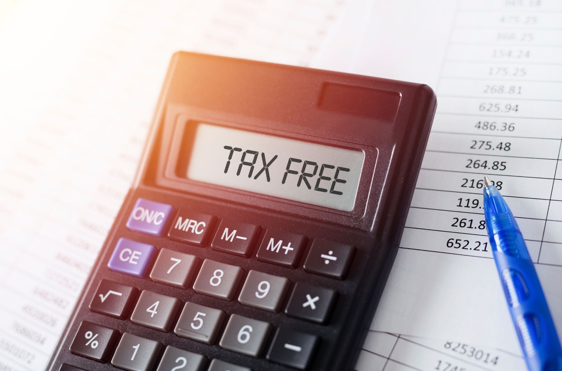 Calculator Saying "Tax-Free" With tax Paperwork