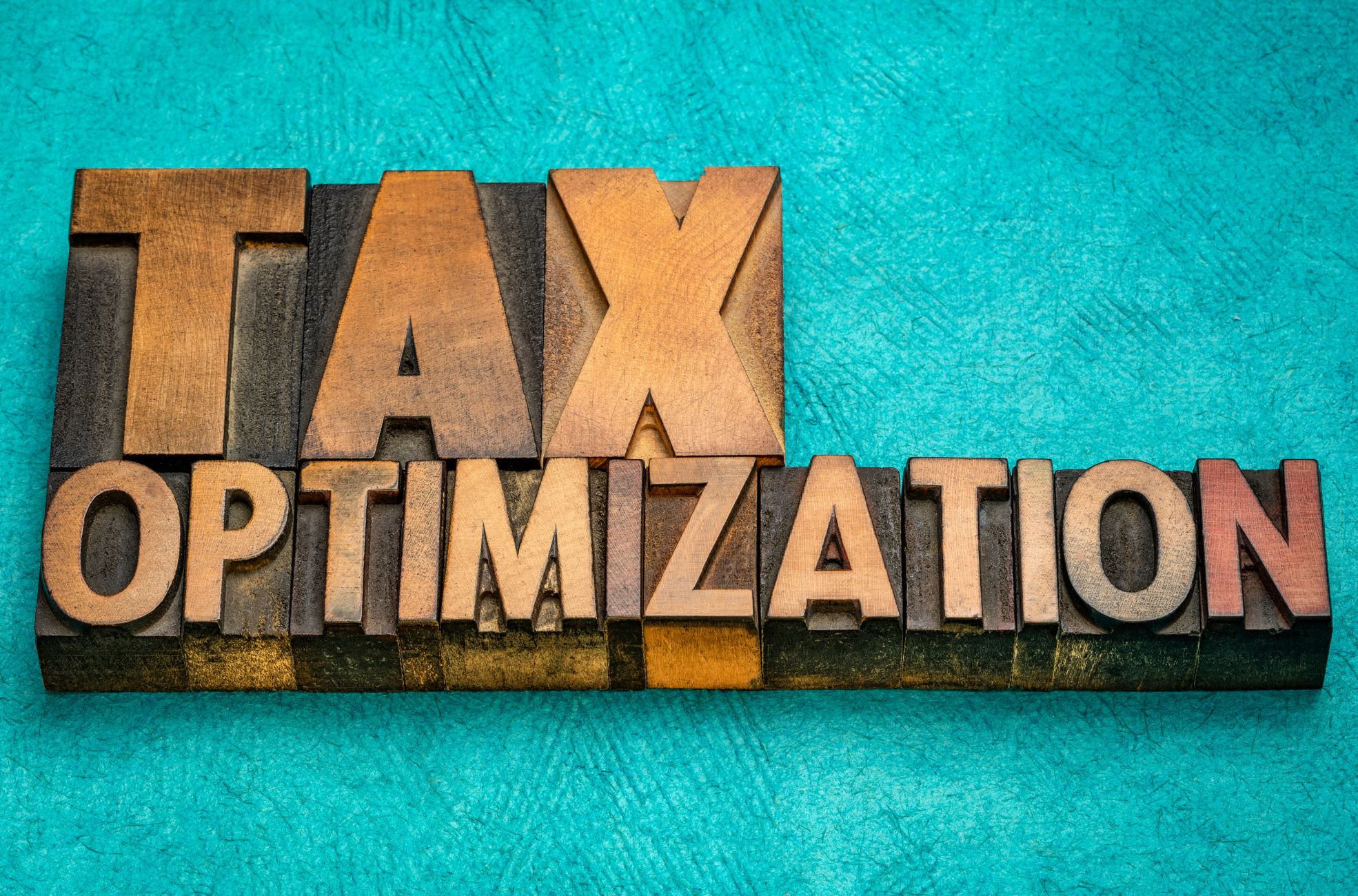 Block Words On Teal Background Reading "Tax Optimization"