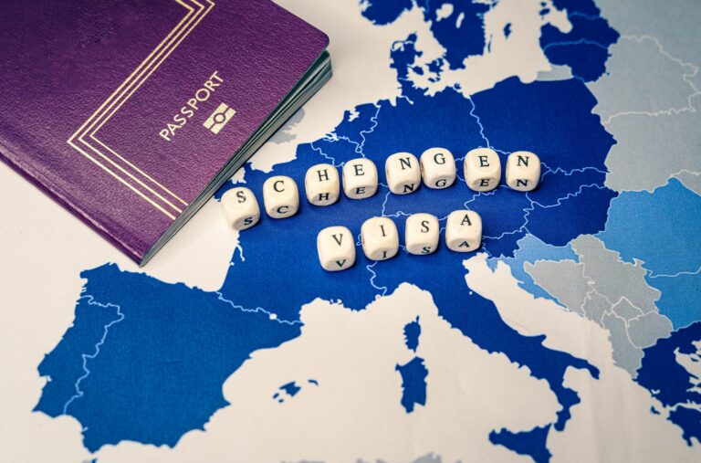 Passport, Map And Tiles Spelling "Schengen Visa"